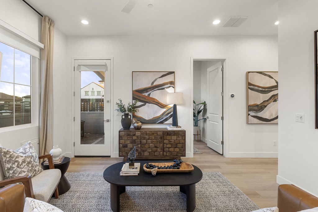 A living room with a fireplace and a painting on the wall.