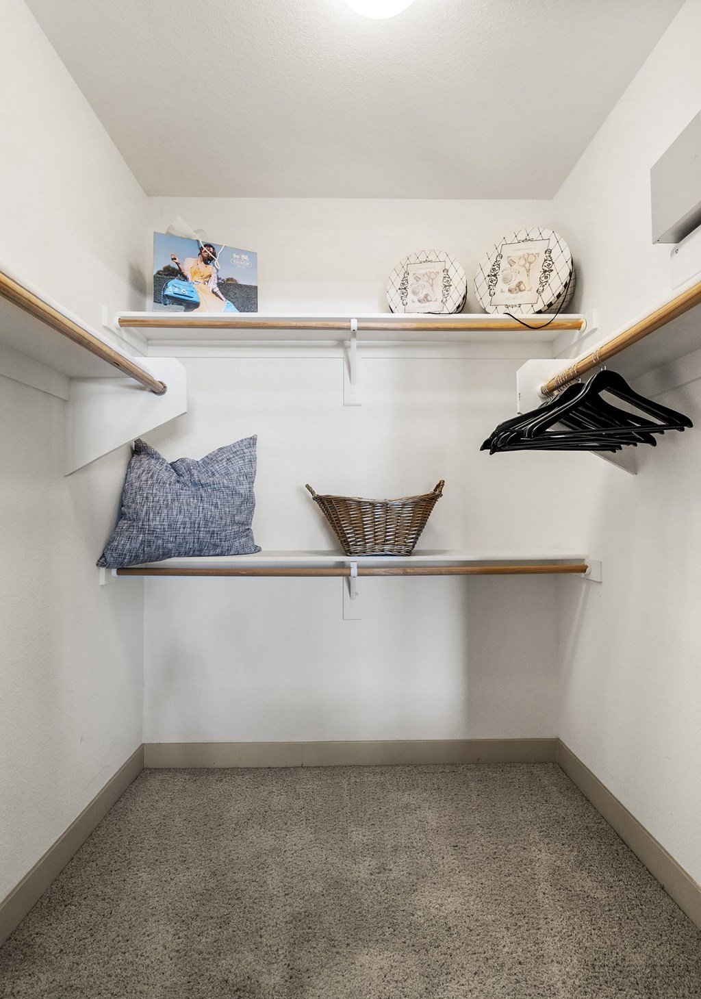 A small closet with a bench and a shelf.