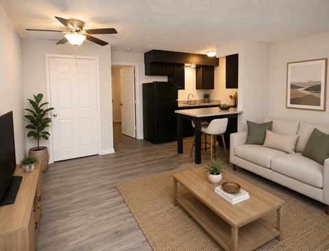 A living room with a couch, a coffee table, and a television.