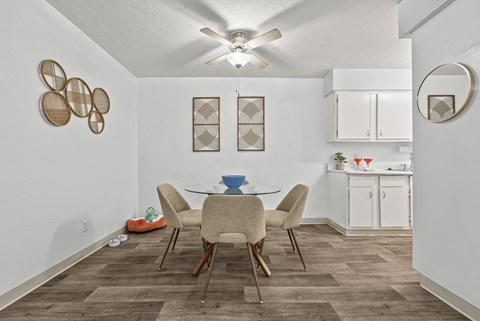 A dining room with a table and chairs.