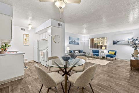 A modern kitchen with a dining table and chairs.