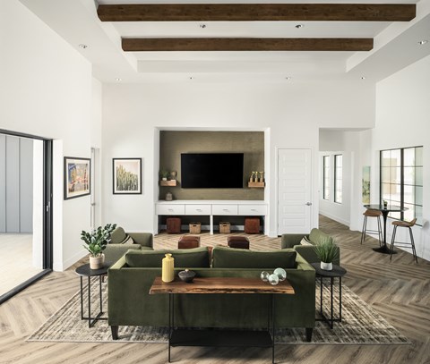 A living room with a green couch and a wooden coffee table.