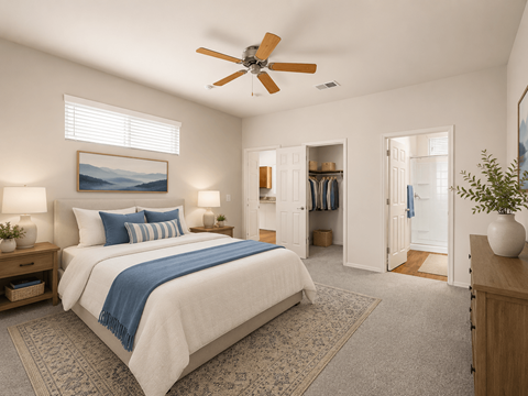 A bedroom with a large bed and a ceiling fan.