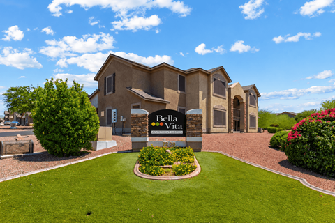 A large house with a sign that says "Bella Vita" in front of it.