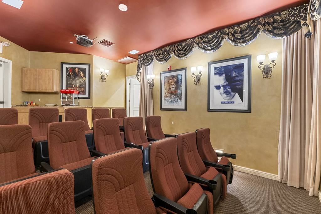 A row of red seats in a movie theater.