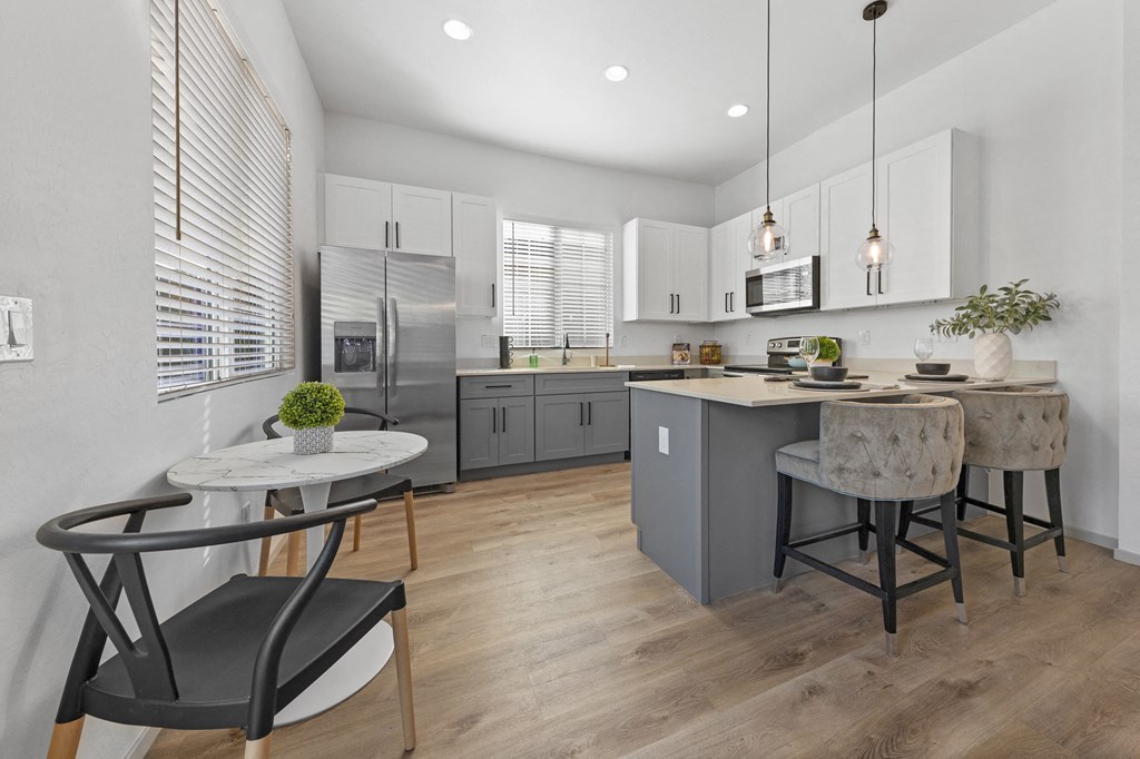 an open kitchen and dining area with a table and chairs