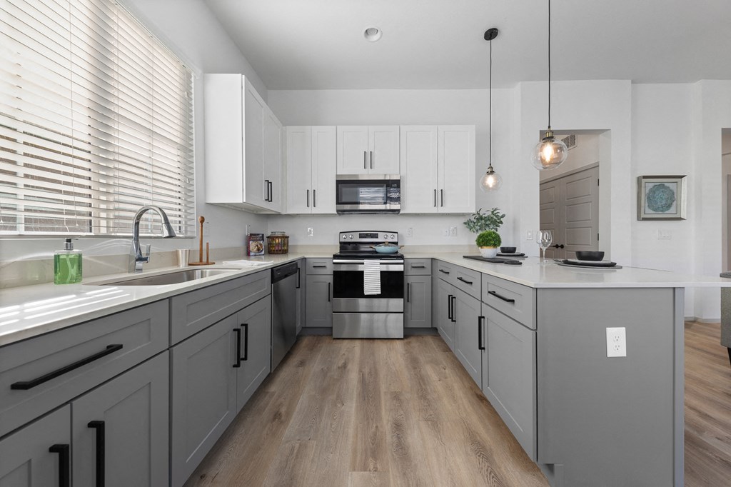 a large kitchen with white cabinets and a white counter top