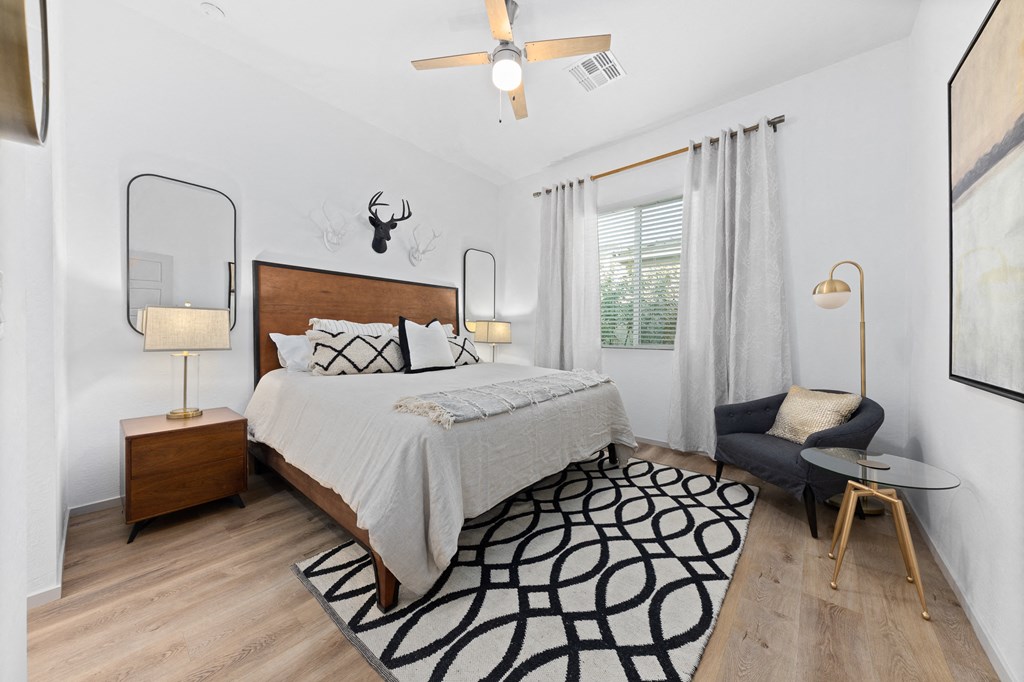 a bedroom with a bed and a ceiling fan