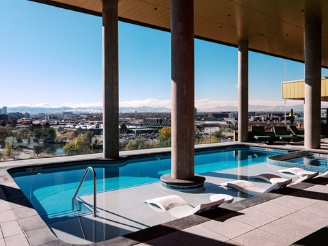A swimming pool with a view of the cityscape.