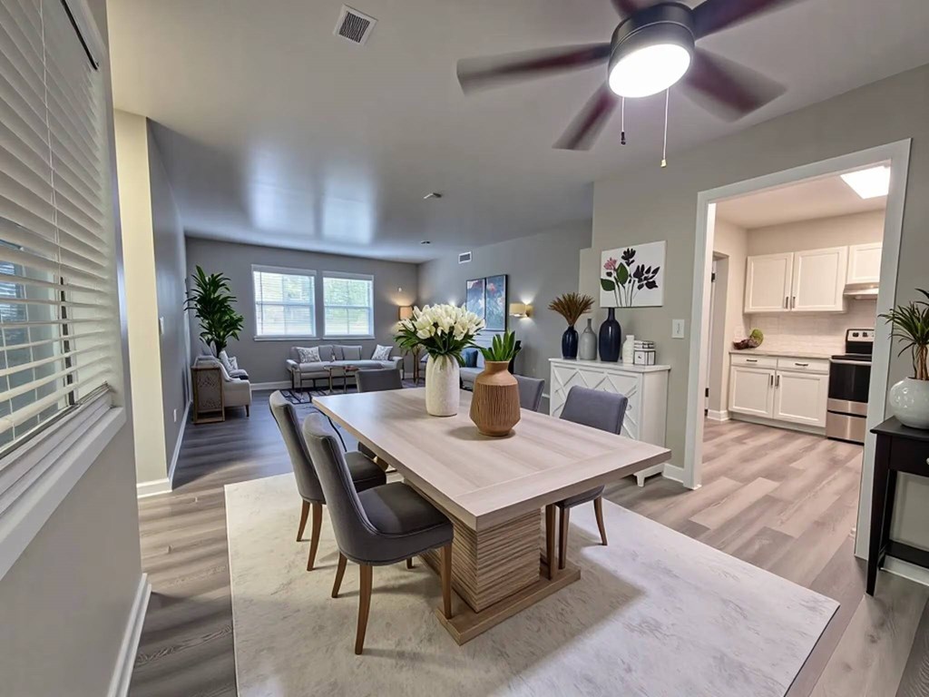 A modern dining room with a wooden table and chairs.