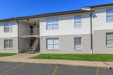 A building with a parking lot in front.