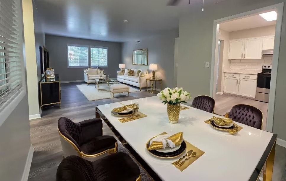A dining room with a table set for a meal.