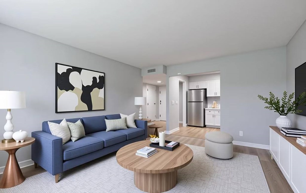 A living room with a blue couch and a coffee table.