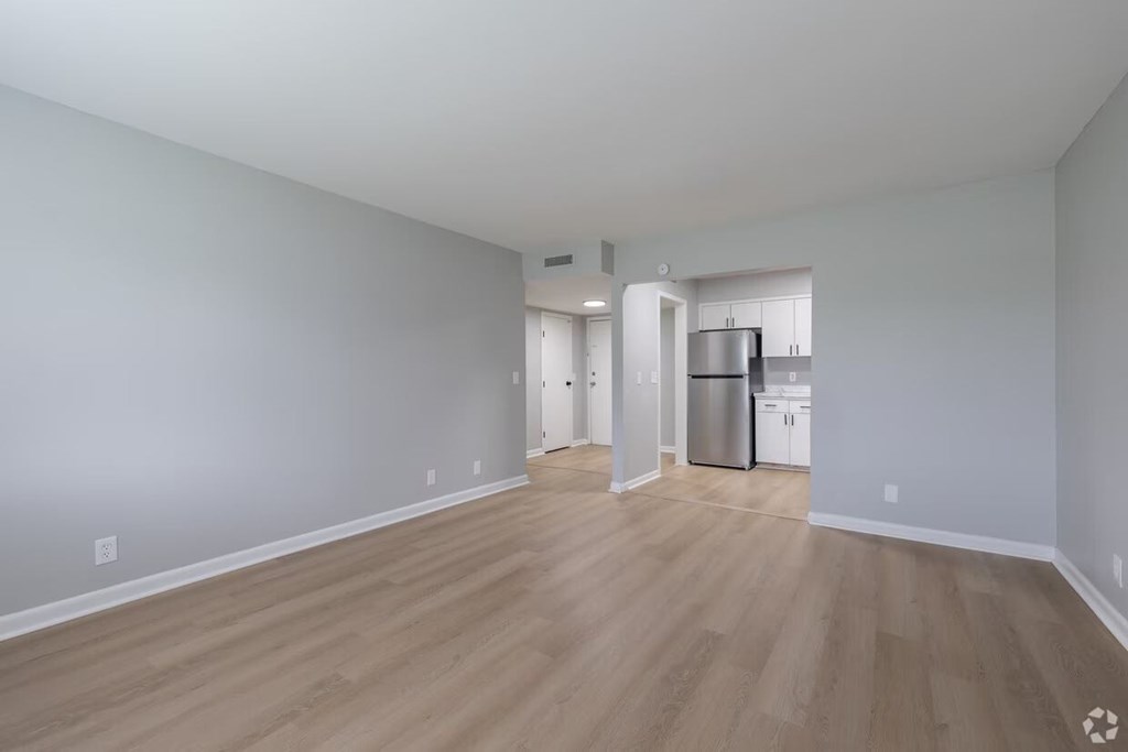 A kitchen area with a refrigerator, dishwasher, and oven.