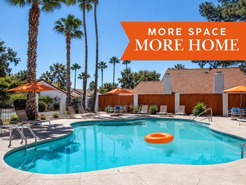 A pool surrounded by palm trees and a sign that says "More Space More Home".