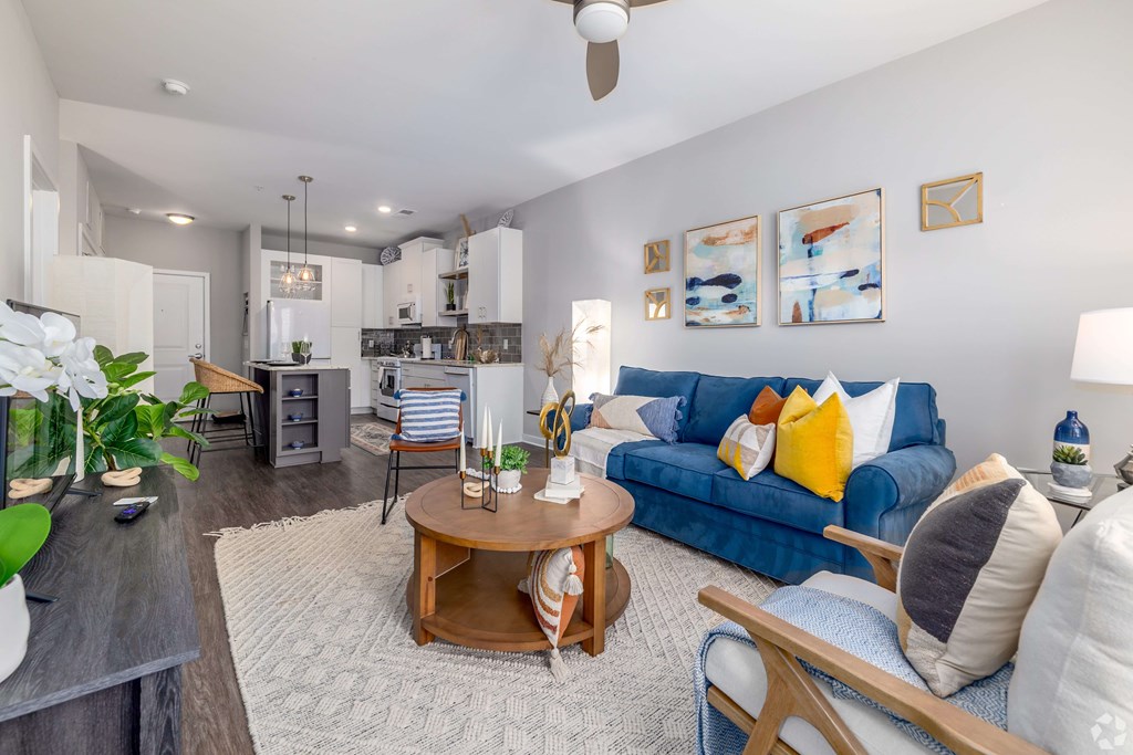 A living room with a blue couch and a coffee table.