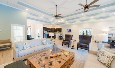 A living room with a couch, chairs, and a coffee table.