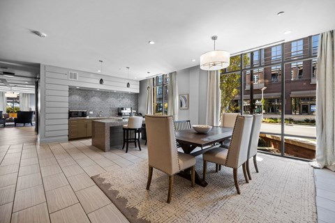 A modern dining room with a table set for four.