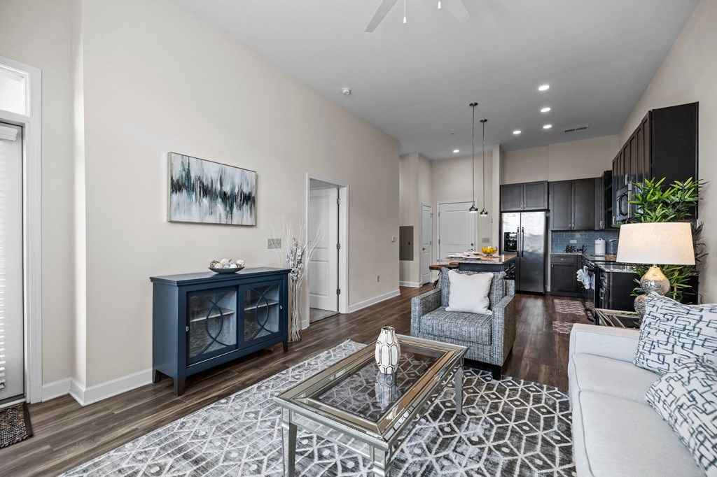 A modern living room with a dark blue cabinet and a grey sofa.