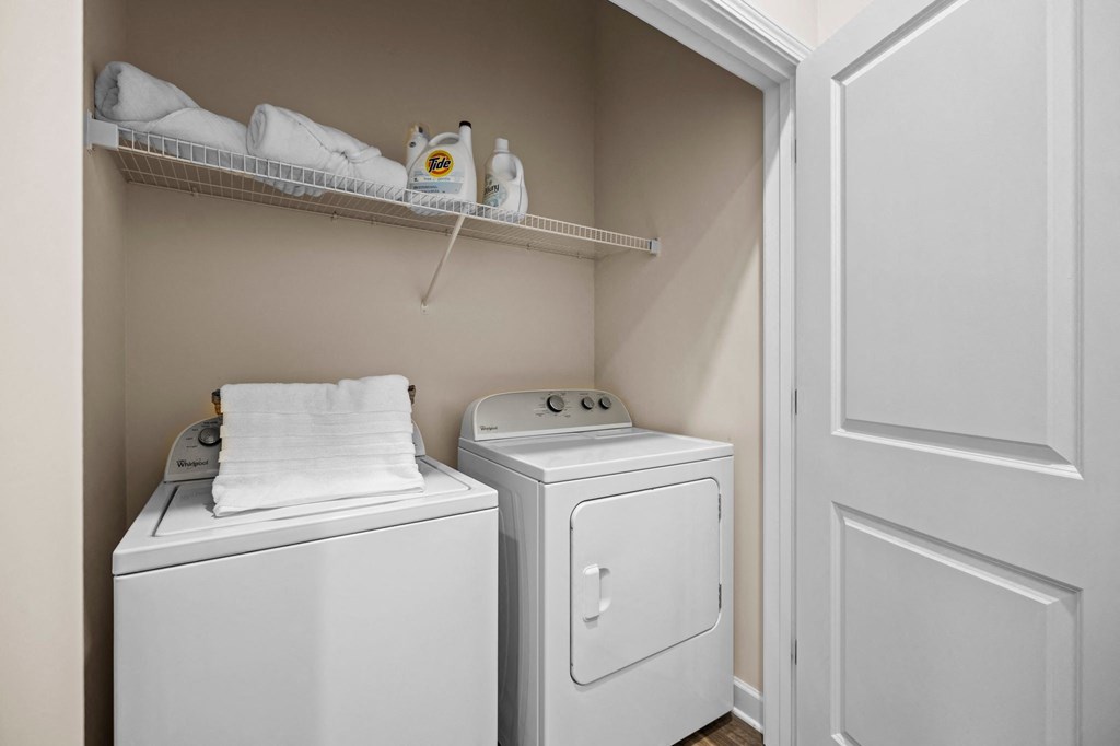 A small laundry room with a washer and dryer.