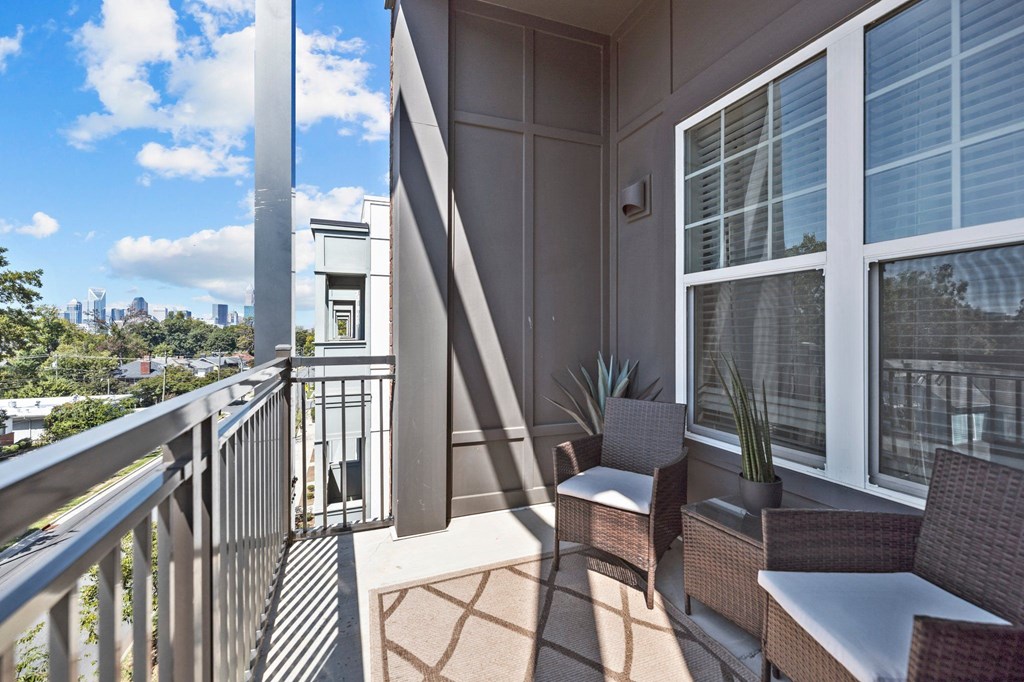 A balcony with a chair and a table.