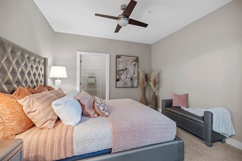 A bedroom with a large bed and a smaller bed in the corner.