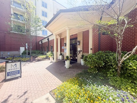 The entrance to the Mezzanine Learning Center is framed by a row of potted plants.
