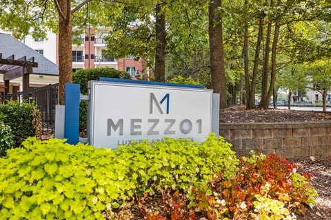 A sign for Mezzozo is in front of a building.