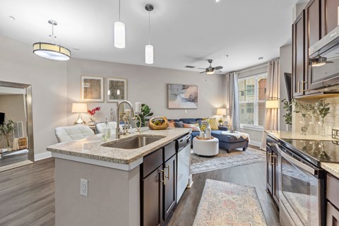 A modern kitchen with a large island and a dining area.