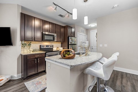 A kitchen with brown cabinets and a white island.