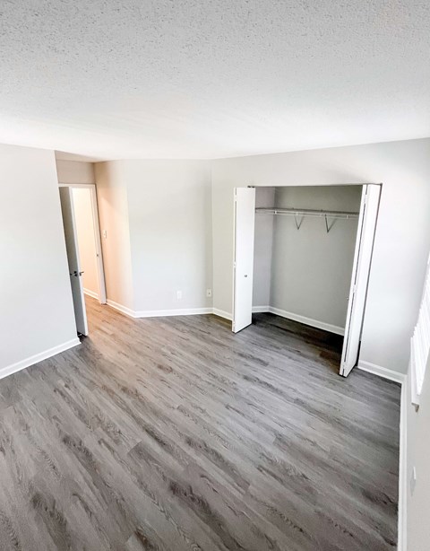 A room with a grey floor and a white door.