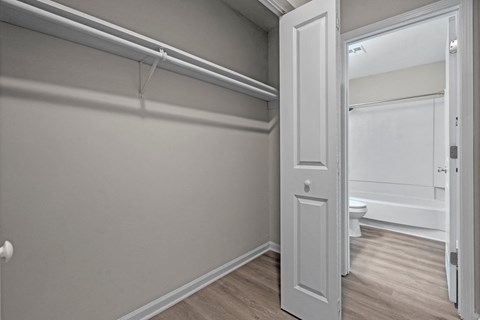 A white door is open to a bathroom.