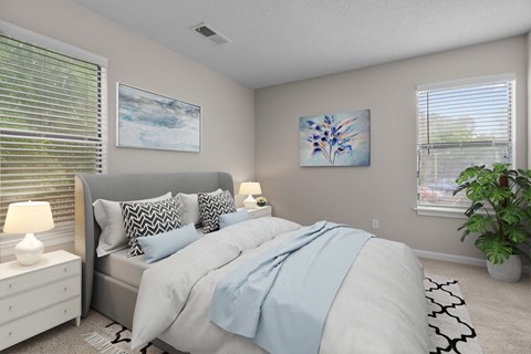 A bedroom with a bed, nightstand, and a painting on the wall.