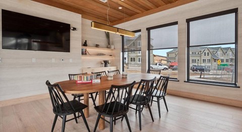 A modern dining room with a wooden table and chairs.