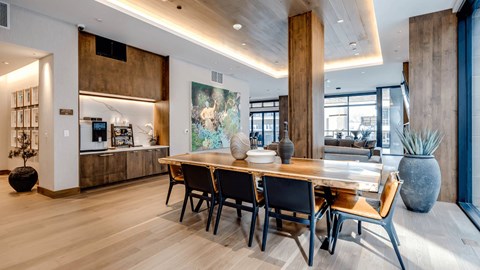 A modern dining room with a wooden table and chairs.