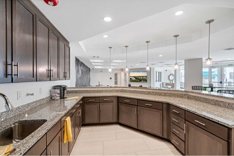 A kitchen with brown cabinets and granite countertops.