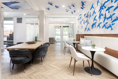 A modern dining room with a large table and chairs.