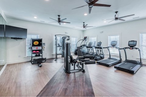 A spacious home gym with a variety of exercise equipment.