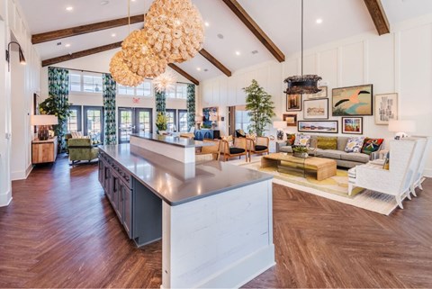A modern kitchen with a large island and a dining area with a table set for four.