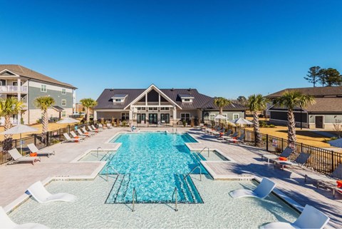 A large swimming pool with a slide in the middle.
