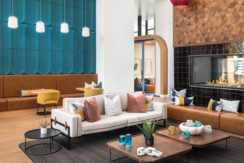 A modern living room with a white sofa and a wooden coffee table.