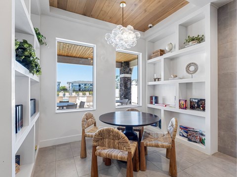 A dining room with a round table and chairs.