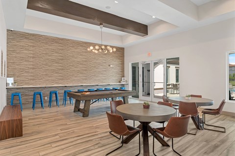 A modern dining room with a round table and chairs.