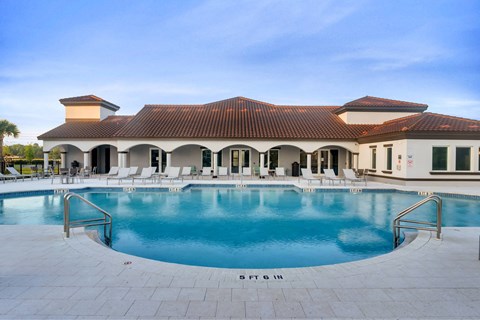 A large house with a pool in front.