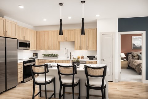 A modern kitchen with wooden cabinets and a stainless steel refrigerator.