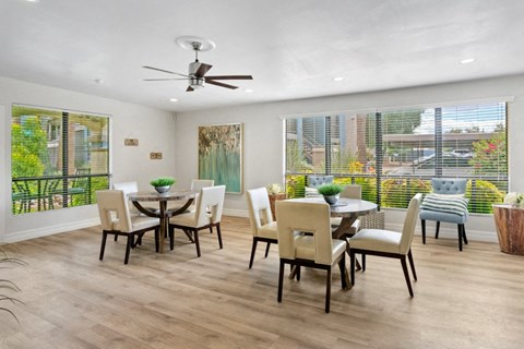 A dining room with a table set for six.