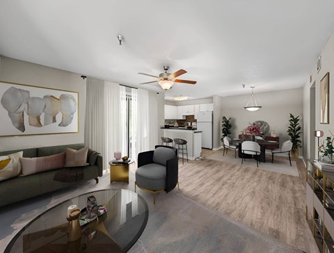 A modern living room with a glass coffee table and a grey sofa.