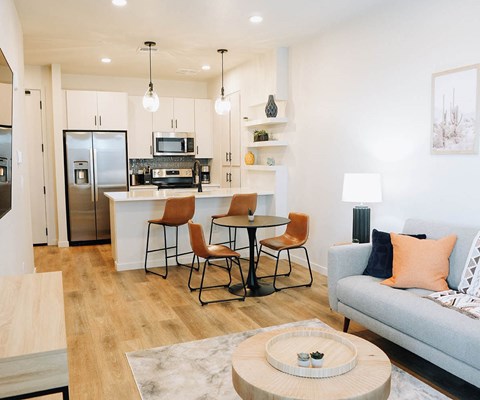 A modern kitchen with a dining table and chairs.