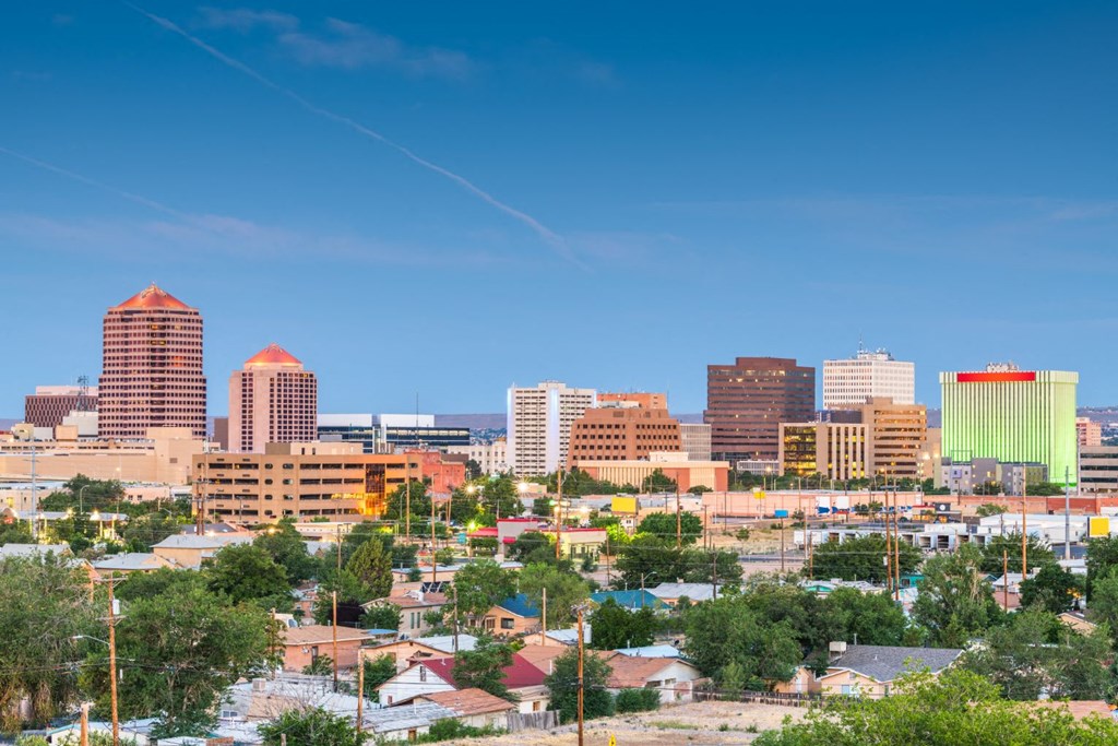 a city skyline with a blue sky in the background