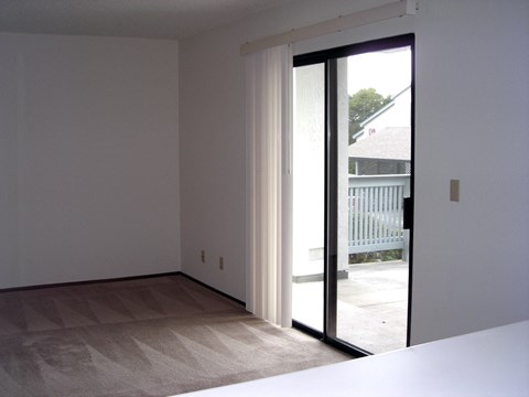 the living room has a sliding glass door to the patio